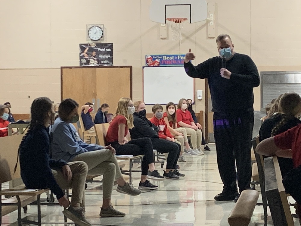 Saint Dominic students learn about the Holy Moments in the life of Saint Therese with Father Tom.