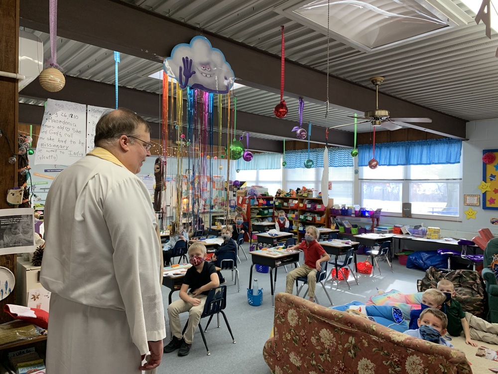 Father Tom blesses classrooms on the Feast of the Epiphany.