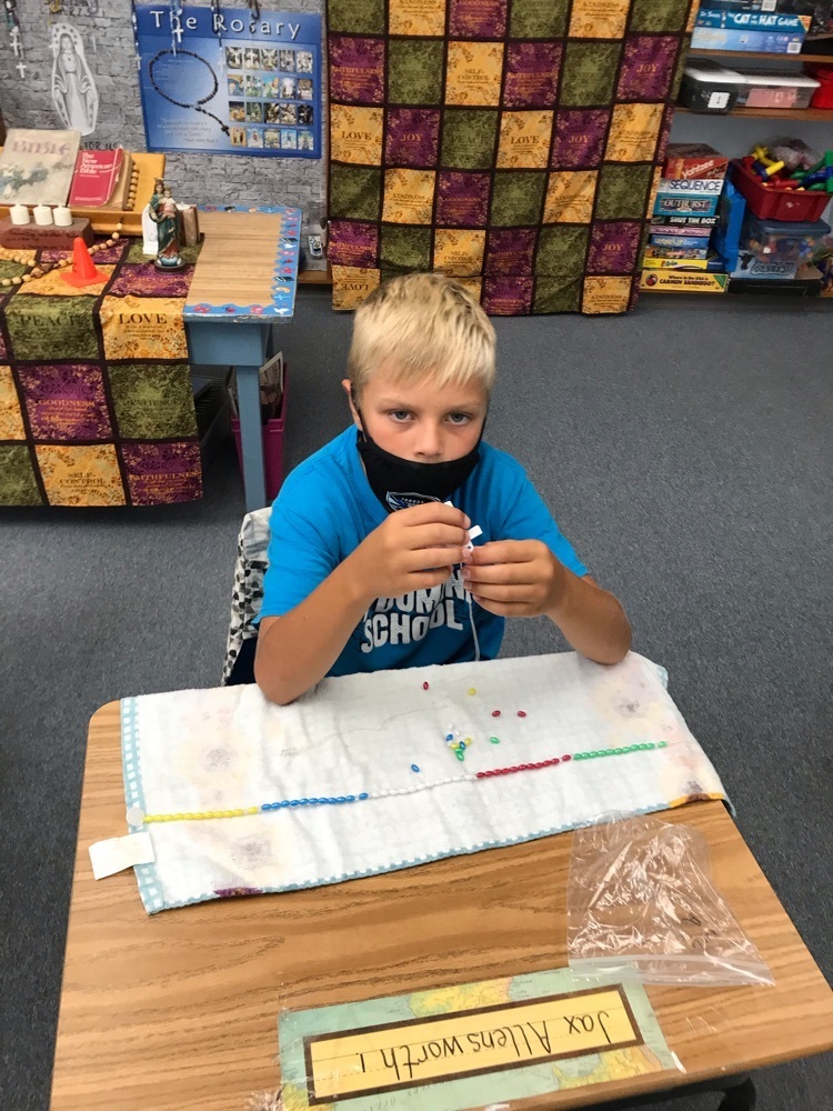 Jax making a rosary.